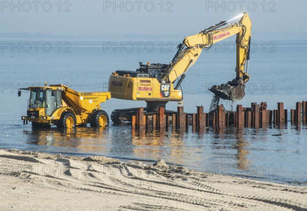 Excavator used in the repair and construction of bathing jetties at Ystads Saltsjöbad, the beach in Ystad, Ystad, Skåne County, Baltic Sea, Sweden, Scandinavia, Europe