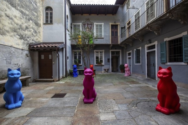 Cat figurines in a backyard of Cannobio, Lake Maggiore, Province of Verbano-Cusio-Ossola, Piedmont Region, Italy, Europe