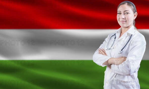Female Doctor On Hungarian Flag. Doctor With Crossed Arms On Hungarian Flag. Hungary Health And Care Concept