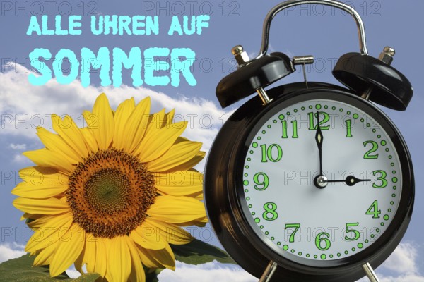 (Photomontage) Summer time changeover Symbol image: Alarm clock, sunflower and text ALL CLOCKS ON SUMMER