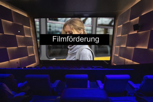 Symbolic image of film funding: FILMFÖRDERUNG text on the screen in a cinema (composing)