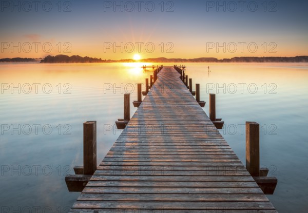 Jetty at Wörthsee at sunrise, fog on the water, Bavaria, Germany, Europe