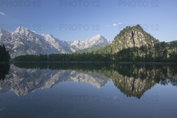 Lake Almsee in summer with totally smooth surface showing reflexion of the mountain Ameisstein