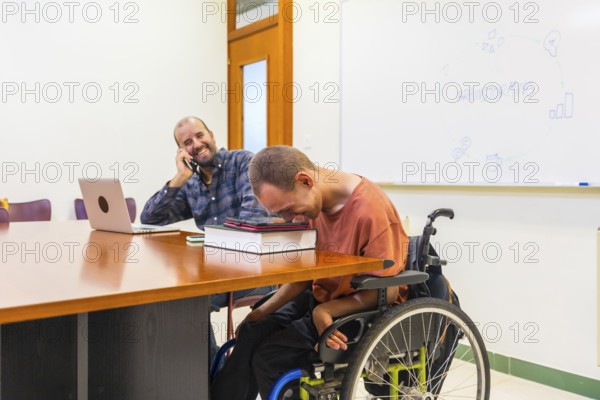 Happy teamwork with a man with disability using tablet in a coworking meeting