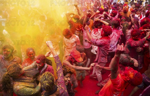 Revellers smear with Gulal or coloured powder and dance to play Holi, the Hindu spring festival of colours, on March 14, 2025 in Guwahati, India, Asia