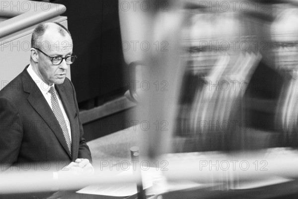 Berlin, Germany - 18 March 2025: Friedrich Merz, CDU Chairman and Chancellor-designate, speaks in the Bundestag in front of the vote on reforming the debt brake to allow hundreds of billions of euros to be borrowed for defence, infrastructure and climate protection, which requires a two-thirds majority of MPs to amend the Basic Law. The SPD and CDU/CSU had introduced the bill to amend the Basic Law in special sessions in the old Bundestag and put it to the vote due to different majorities in the new Bundestag, which will be constituted next week. Note: the photo was subsequently converted to b/w