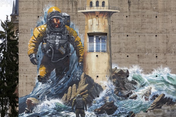 Astronaut standing in surf, mural on the subject of climate change on a bunker, by street art artist duo Tubuku, Krefeld, North Rhine-Westphalia, Germany, Europe