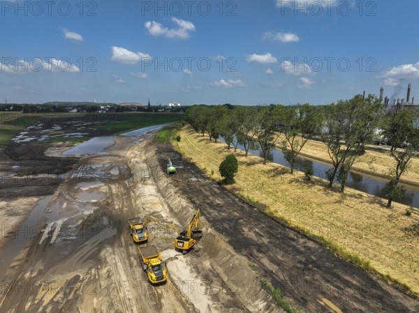 Oberhausen, North Rhine-Westphalia, Germany, renaturalisation of the Emscher in the Holtener Bruch. OQ Chemicals plant Ruhrchemie on the right. The currently straightened Emscher, shown here at flood level, has been given curves again and can meander through its new floodplain. The ecological conversion of the Emscher system consists of the construction of a centralised wastewater treatment system in the Ruhr region, the construction of sewers and the renaturation of the Emscher and its tributaries. Following the construction of a parallel sewer, the Emscher has been completely free of sewage since January 2022. The river was previously an open, above-ground combined sewer with rainwater and wastewater, Europe