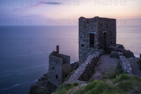 The ruins of the Crowns Engine Houses of the Botallack Mine, also known as the Crown Mine. In the evening, after sunset. Long exposure. Botallack, Penzance, Cornwall, England, Great Britain