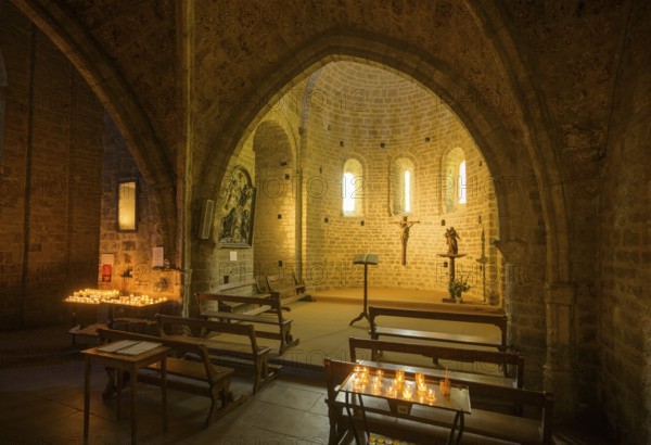 Side chapel with burning candles in the Abbey of Gellone, also Saint-Guilhem-le-Désert Monastery, Département Hérault, France, Europe