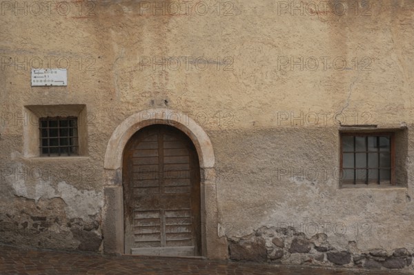 View of a wooden door and window of an old building, St.Peter, Villnöß, Funes, Villnößtal, South Tyrol, Italy, Europe