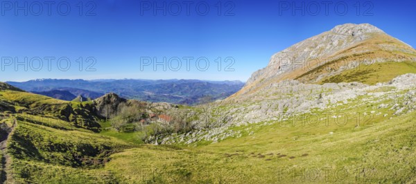 Scenic view of a hiking trail ascending towards mount txindoki, showcasing the natural beauty of the basque country in gipuzkoa