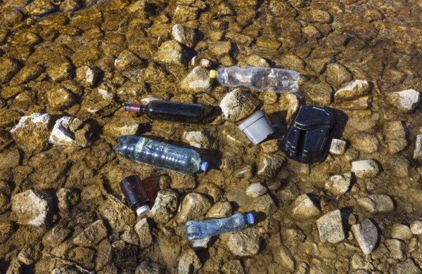Environmental pollution, Household waste washed up on the lake shore, Plastic and glass bottles, Austria, Europe