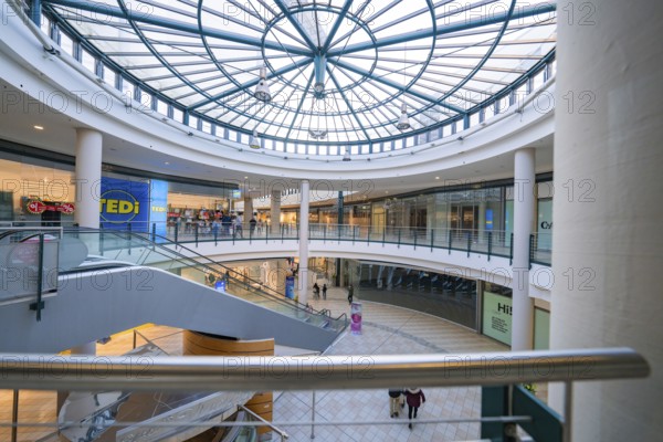 Interior of a large shopping centre with a large glass roof and escalator, Sterncenter Sindelfingen, Böblingen district, Germany, Europe