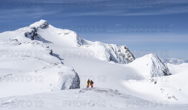 Two ski tourers in front of a snow-covered mountain landscape, Wildhorn in winter, Bernese Alps, Bernese Oberland, Switzerland, Europe
