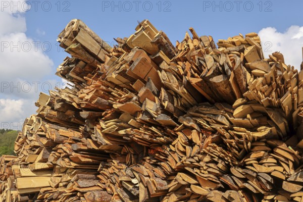 Solingen, North Rhine-Westphalia, Germany - Residual wood in the timber store of a sawmill is processed into wood chips and used as fuel in a combined heat and power plant, construction timber is scarce and expensive, carpentry and joinery companies are struggling with rapidly rising raw timber prices in times of the corona crisis, large quantities of logs are exported to China and the USA