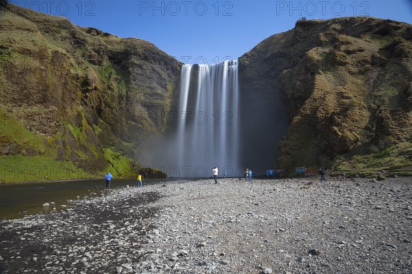 Skógafoss is a waterfall situated on the Skógá River in the south of Iceland. Height 60 m, width 25 m. People in front of the fall