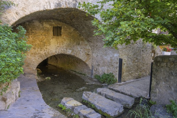Stepping stones over a water channel, Saint-Guilhem-le-Désert, Département Hérault, France, Europe