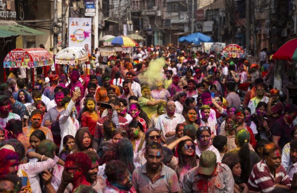 Revellers smear with Gulal or coloured powder and dance to play Holi, the Hindu spring festival of colours, on March 14, 2025 in Guwahati, India, Asia