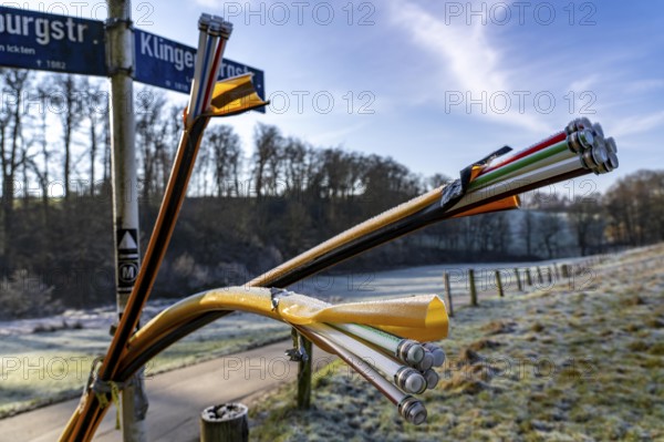 Fibre optic connection, empty conduits protrude from the ground along a dirt track, into which the actual fibre optic cable is later blown and connected to the respective house connection or distributor, provision of fast Internet in rural areas, in the south of Mülheim an der Ruhr, North Rhine-Westphalia, Germany, Europe