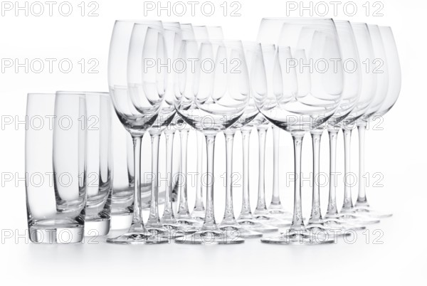 Different empty glasses in front of a white background, studio shot
