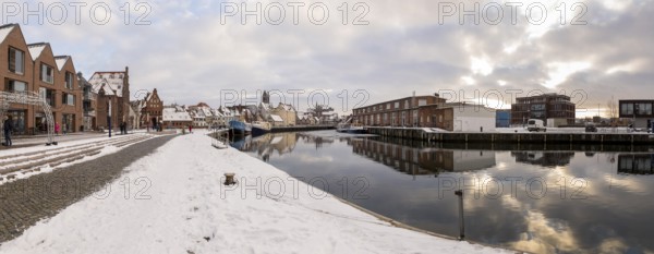 Panorama of the old town and harbour with water gate, St. Mary's Church and St. George's Church in snowy weather, Hanseatic city of Wismar, Mecklenburg-Western Pomerania, Germany, Europe