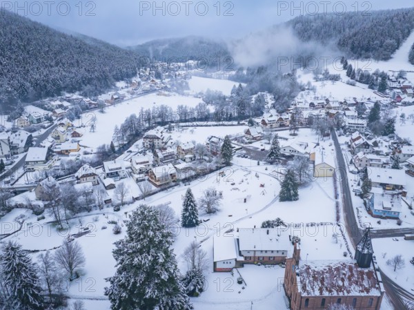 Snow-covered village in a valley surrounded by wooded hills, Enzklösterle, district of Calw, Black Forest, Germany, Europe