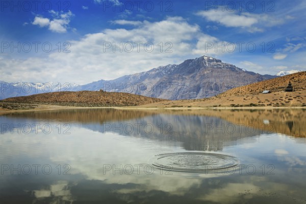Himalayas mountains refelcting in mountain lake Dhankar Lake. Spiti Valley, Himachal Pradesh, India, Asia