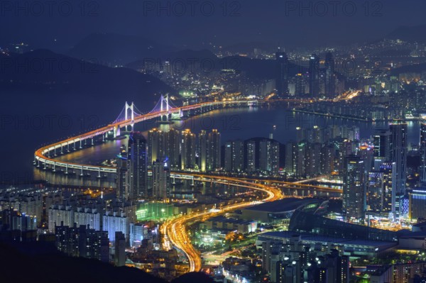 Busan cityscape with skyscrapers and Gwangan Bridge illuminated at night. Busan. South Korea