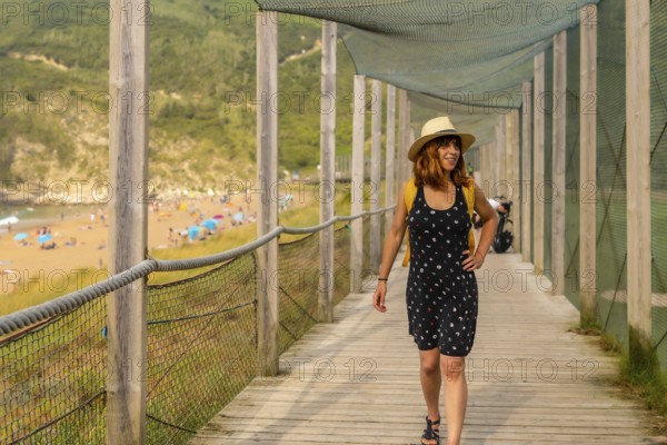 Young and adventurous girl enjoying summer vacation walking alone along the beach