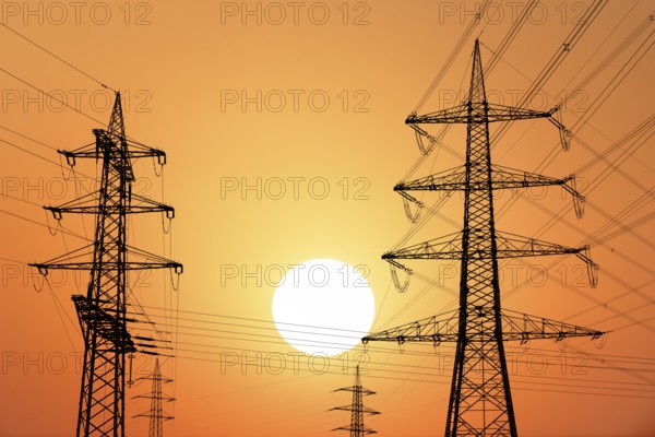 Overhead power lines, high-voltage pylons, power lines, setting sun, sunset, Baden-Württemberg