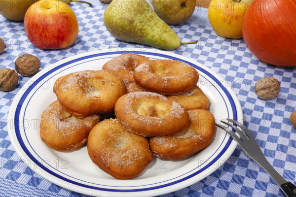Swabian cuisine, harvest cakes, dessert, dessert, fat baked goods, doughnuts, fried food, lard noodles, arranged on a plate, grandmother's kitchen, regional, home cooking, typical Swabian, classic recipe, traditional cuisine, food photography, autumn atmosphere, apples, pears, nuts, still life, studio, Germany, Europe