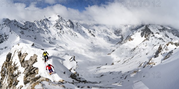 Two mountaineers climbing the narrow ridge of Piz Laviner, view of mountain panorama in winter mountain landscape, Grisons Haute Route, Albula Alps, Rhaetian Alps, Grisons, Eastern Switzerland, Switzerland, Europe