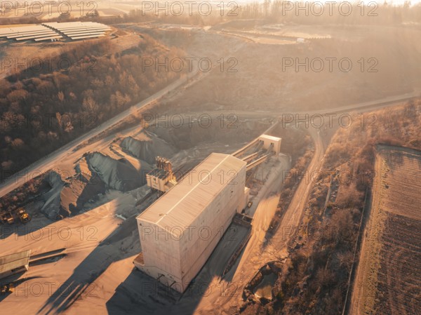 Overview of a quarry with buildings in hilly surroundings at dusk, Magstadt, Germany, Europe