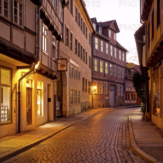 Half-timbered houses in a narrow street with cobblestones, Old Town in the evening, World Heritage City of Quedlinburg, Saxony-Anhalt, Germany, Europe
