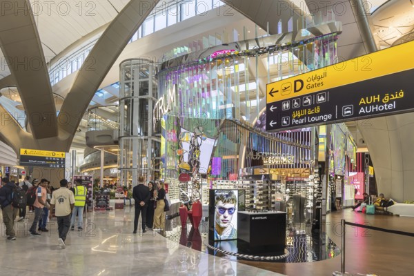 Abu Dhabi Airport, Zayed International Airport with passengers. Duty free shop. The new Terminal A has a capacity of 45 million passengers per year. Modern architecture. Abu Dhabi, United Arab Emirates, UAE, Asia
