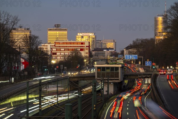 Motorway A40, Ruhr expressway, heavy traffic jam, rush hour, city passage in Essen, skyline of the city centre, underground line between the lanes, Hobeisenbrücke stop, North Rhine-Westphalia, Germany, Europe