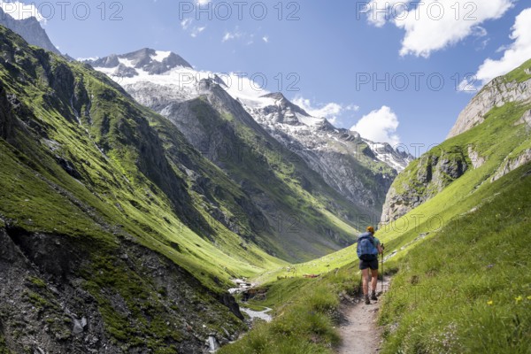 Hiker on hiking trail, view of Großer Schober and Rötspitze, Umbaltal, Hohe Tauern National Park, East Tyrol, Tyrol, Austria, Europe