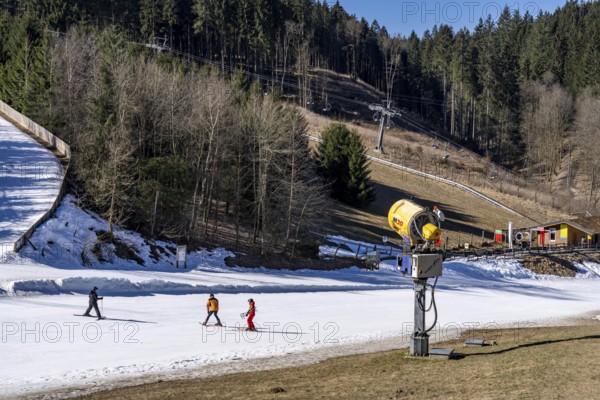 Winter sports area in the Sauerland, Winterberg ski lift carousel, artificial snow slopes, artificial snow from over 360 snow guns, Poppenberg ski area, quick jet lift, 12 of 24 lifts are in operation in mid-March, the rest of the landscape is snow-free, North Rhine-Westphalia, Germany, Europe
