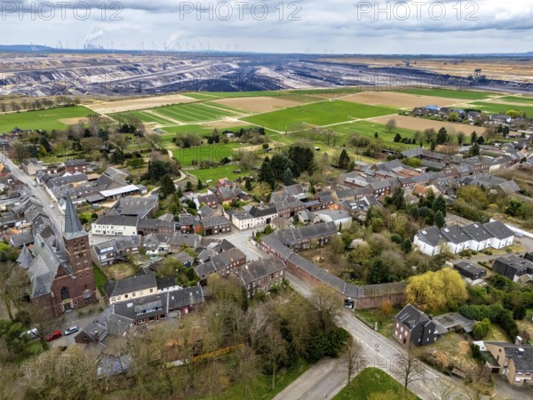 The village of Keyenberg at the Garzweiler II open-cast lignite mining area, the original village was to be dredged, but now remains due to the lignite phase-out in 2030, the former residents now live around 6 kilometres away in the district of Erkelenz, in Keyenberg-Neu, North Rhine-Westphalia, Germany, Europe