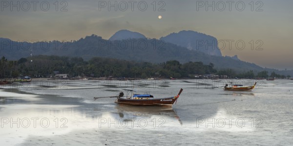 Before sunrise, longtail boats lie at low tide in the harbour at Sivalai Beach, Koh Mook Island, Satun Province, Southern Thailand, Thailand, Asia