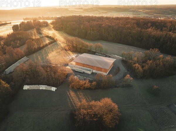 Photograph of a building in a rural setting with long shadows at dusk, Gechingen, Heckengäu region, Calw district, Germany, Europe