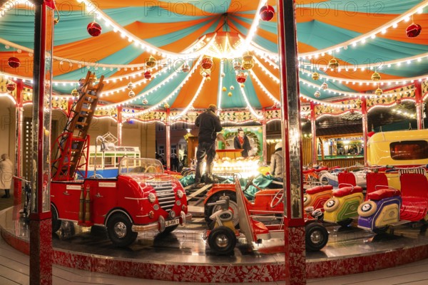A colourful carousel with fairy lights in a lively night-time atmosphere, Ludwigsburg Christmas Market, Germany, Europe