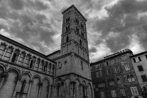 Dark rain clouds over the bell tower of the church of San Michele in Foro, historic city centre, black and white photo, Lucca, Tuscany, Italy, Europe