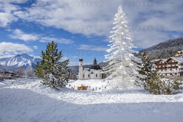 Seekirchl with artificial winter fir tree and Hocheder 2797m in winter, Seefeld, Seefeld Plateau, Tyrol, Austria, Europe