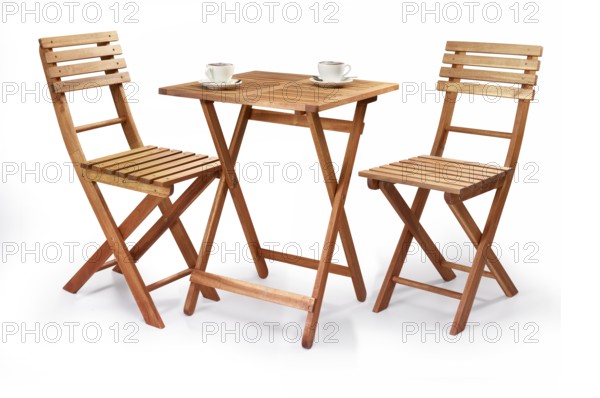 Balcony or bistro set, 2 folding chairs and wooden end table in front of a white background, two cappuccino cups on the table, studio shot