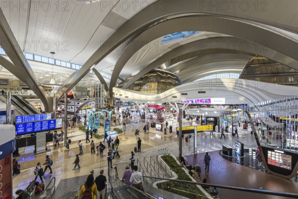 Abu Dhabi Airport, Zayed International Airport with passengers. The new Terminal A has a capacity of 45 million passengers per year. Modern architecture. Abu Dhabi, United Arab Emirates, UAE, Asia
