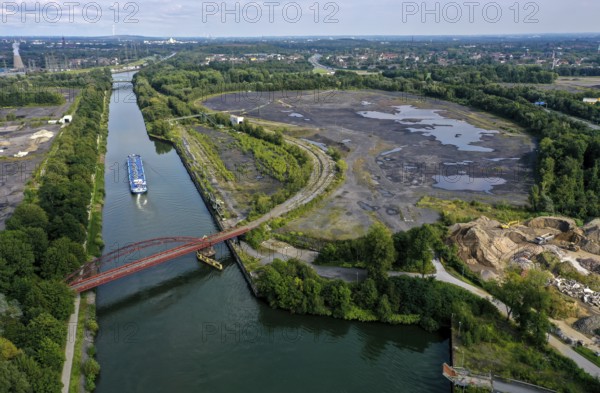 Essen, North Rhine-Westphalia, Germany - FREIHEIT EMSCHER urban development project. The cities of Essen and Bottrop, together with the owner RAG Montan Immobilien GmbH, want to transform former mining sites on the Rhine-Herne Canal and Emscher into an urban centre with commerce and industry, residential areas as well as green spaces and leisure facilities on the waterfront. The so-called nucleus, consisting of the Sturmshof site (left) on the Bottrop side of the Rhine-Herne Canal and the Coelln-Neuessen harbour (right) on the Essen side, plays a special role here