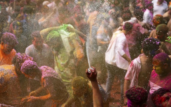Revellers smear with Gulal or coloured powder and dance to play Holi, the Hindu spring festival of colours, on March 14, 2025 in Guwahati, India, Asia