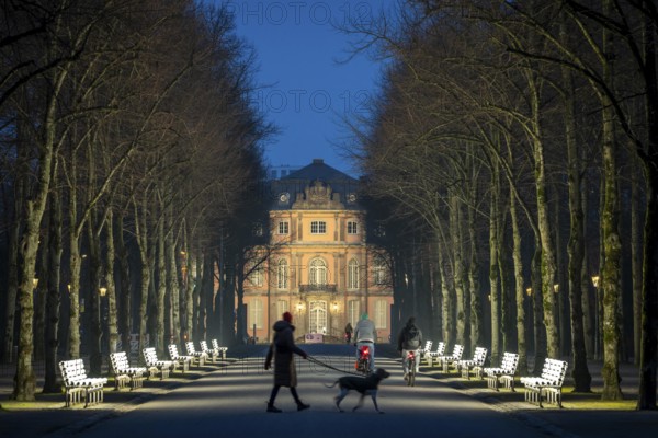 The light benches by artist Stefan Sous in the Hofgarten, entitled UV-A UV-B, 14 completely refurbished exhibits from the 2002 light-grey art exhibition, which now stand and light up as a permanent work of art on Jägerhofallee, LED technology, in the background Jägerhof Palace, home of the Goethe Museum, Düsseldorf, North Rhine-Westphalia, Germany, Europe